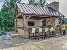 Exterior photo of 16' x 20' Custom Timber Frame Pavilion with Double Sided Fireplace & Lean-To Shed in Orefield PA