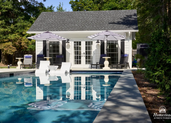 white pool house with french doors and two umbrellas with reflection in an in-ground swimming pool in Silver Spring, MD