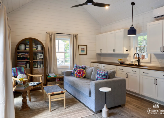 Pool house living area with couch and kitchen with sink