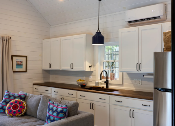 Pool house kitchen with sink and refrigerator, mounted AC unit in Silver Springs, MD