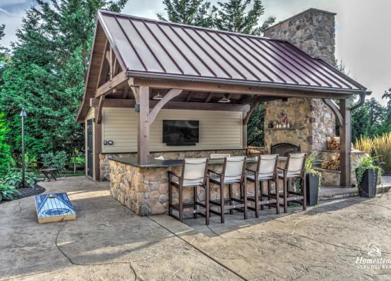 Exterior photo of 16' x 20' Custom Timber Frame Pavilion with Double Sided Fireplace & Lean-To Shed in Orefield PA