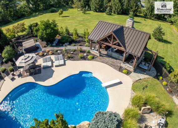 Drone photo of a 20' x 25' Timber Frame Pavilion with Fireplace & Outdoor Kitchen in Pennsburg PA