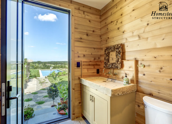 A garage bathroom with a view of the pool